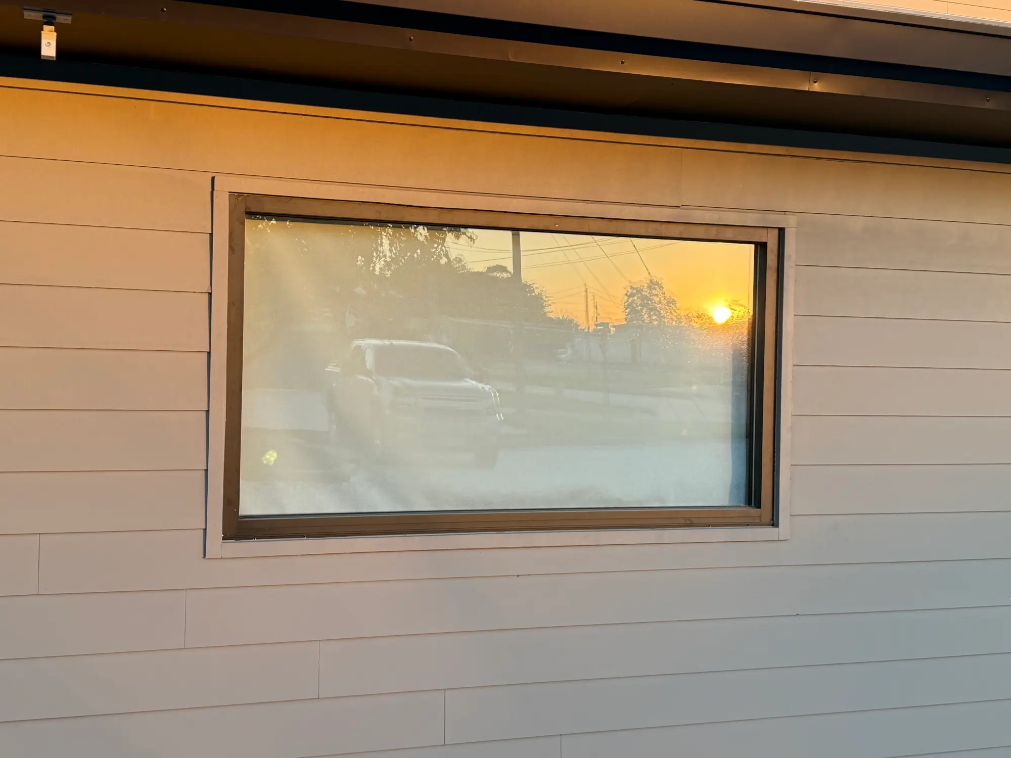 Commercial window and glass installation with metal framing on a professional office building exterior.